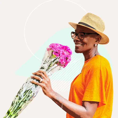 photo of woman holding flowers