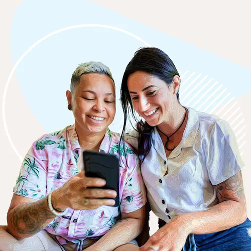 photo of two women looking at a phone