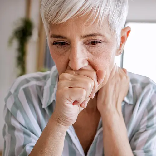 photo of senior woman coughing