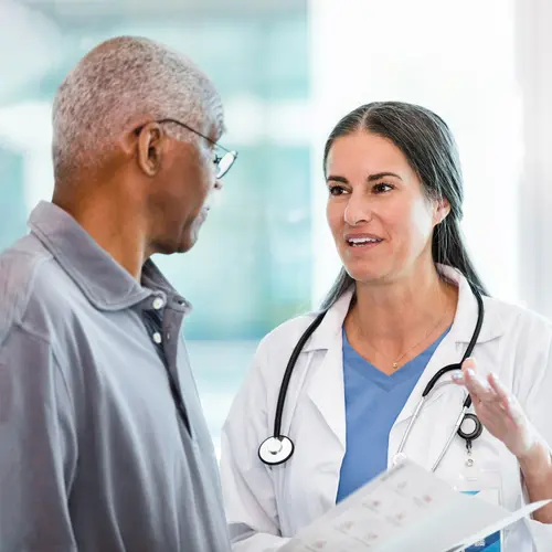 photo of doctor talking with senior patient