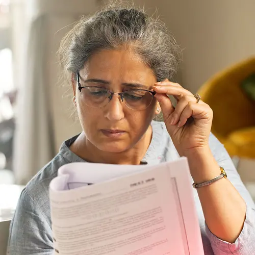 photo of senior woman reading a document