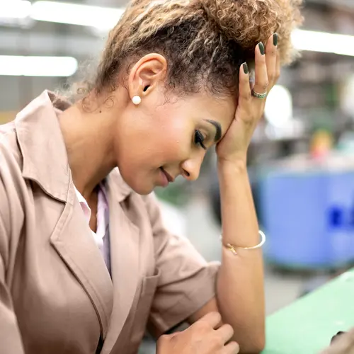 photo of woman in office with headache