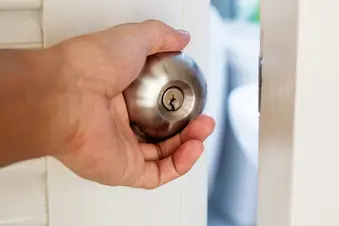photo of man opening bathroom door