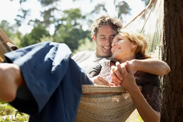 photo of mature couple relaxing in hammock