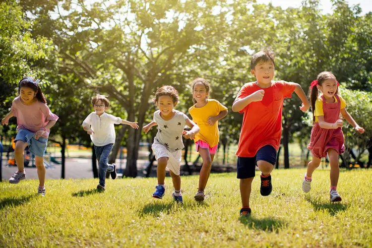 photo of young children laughing and running