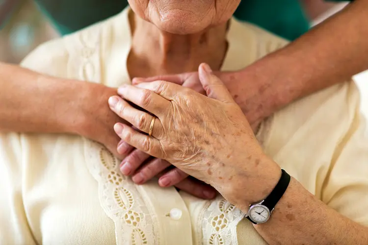 photo of caregiver hugging mother