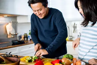 photo of couple cooking healthy meal
