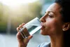 photo of woman drinking glass of water