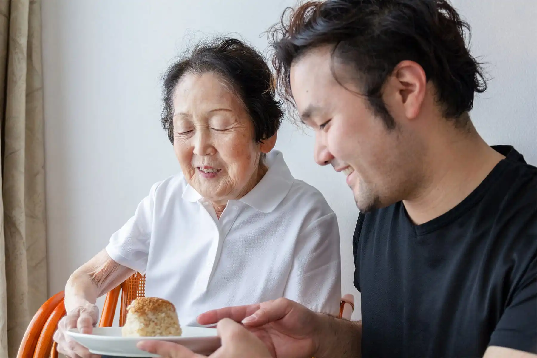 record grandson sharing rice ball with grandmother