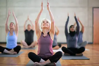 photo of raising arms in yoga class