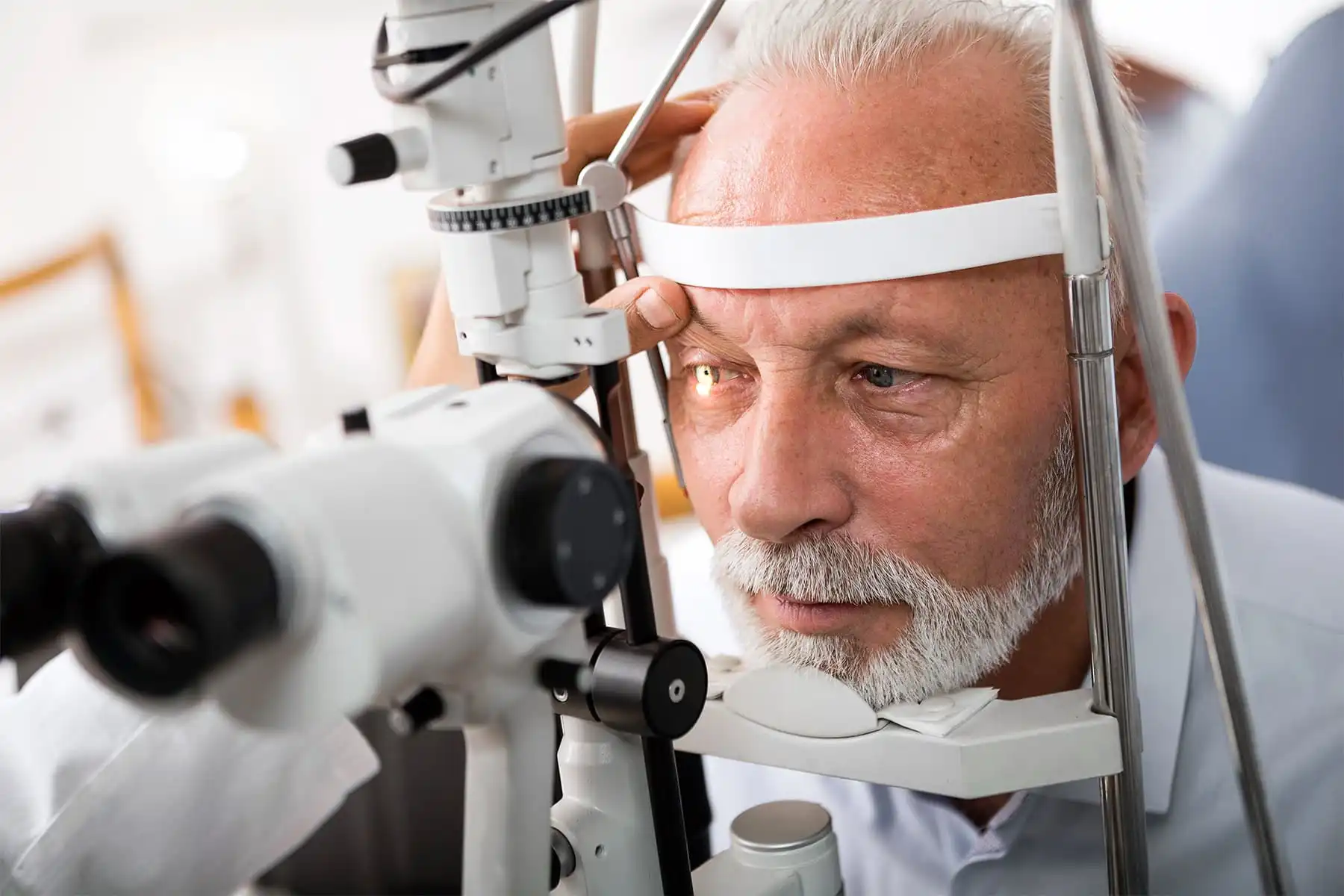 senior man receiving eye exam
