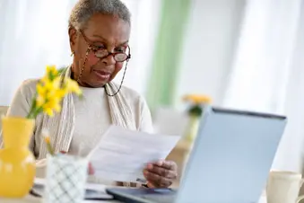 photo of senior woman using laptop computer