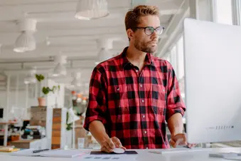 photo of man using standing desk