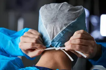 photo of surgeon tying on cap