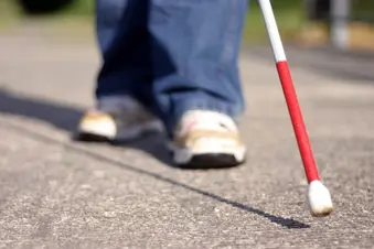 photo of visually impaired with walking cane