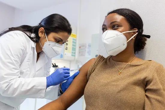 photo of woman receiving vaccine shot