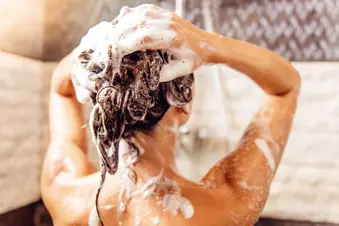 photo of woman shampooing her hair