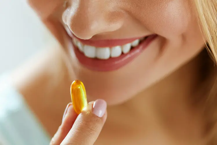 photo of woman taking supplement