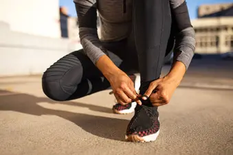 woman tying running shoes