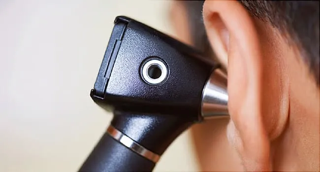 ear exam with otoscope close up