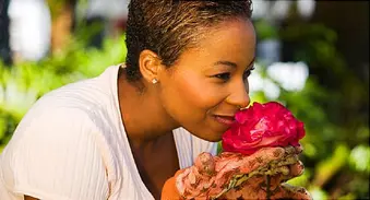 woman smelling rose