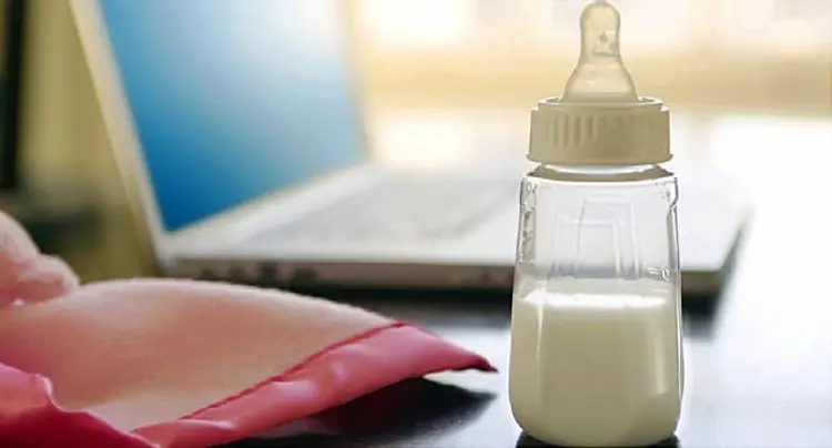 baby bottle by laptop