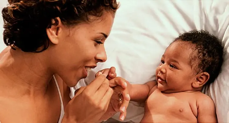 High angle view of a mother playing with her baby