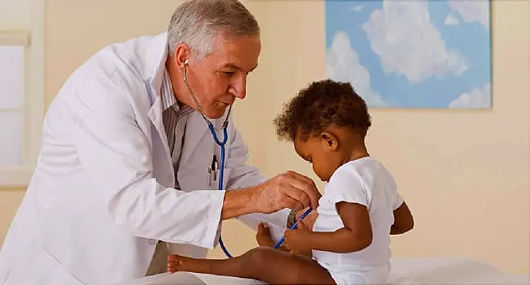 Doctor listening to toddlers heart