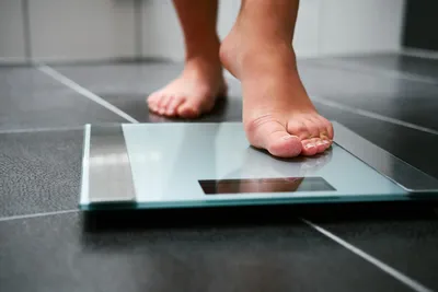 person stepping onto scale