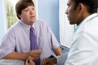 photo of overweight man talking with doctor
