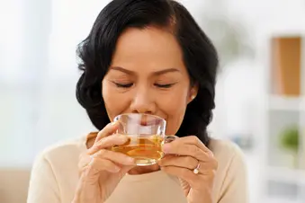 photo of woman drinking cup of hot tea