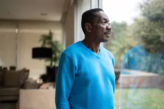 photo of senior man gazing out window