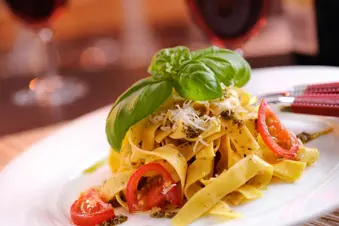 photo of linguini with pesto and parmesan cheese