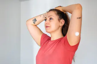 photo of woman wearing glucose meter