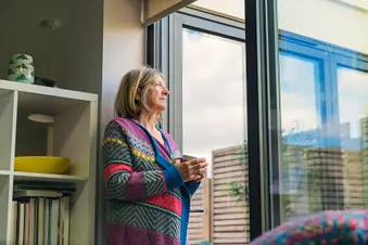 photo of senior woman looking out window