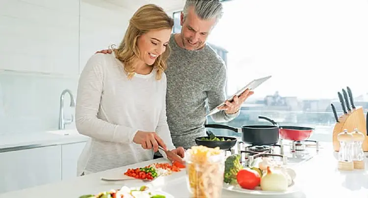 mature couple preparing meal
