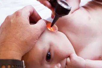 doctor taking baby's temperature