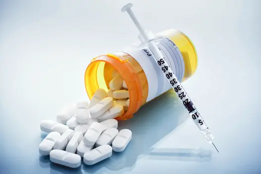 photo of prescription pills and syringe