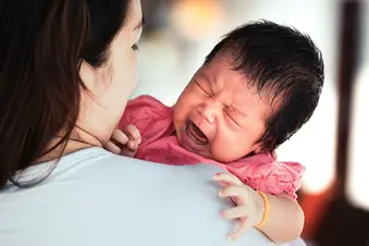 mother comforting crying baby