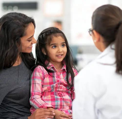 photo of mother and daughter talking with doctor