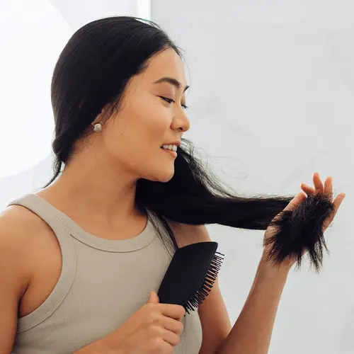 photo of woman brushing hair