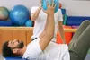 photo of man doing exercises with trainer