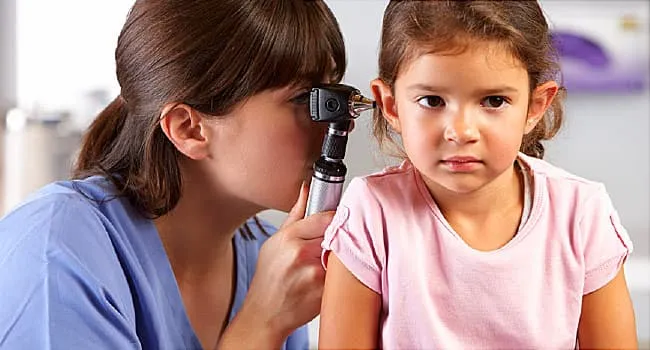 doctor checking girls ear