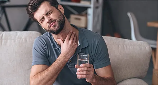 man with throat pain