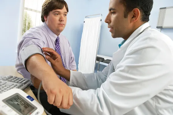 doctor checking blood pressure