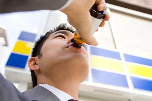 photo of man sipping energy drink