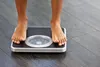 photo of woman's feet on weight scale