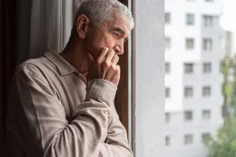 photo of pensive man looking retired window