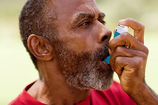 photo of mature man using inhaler