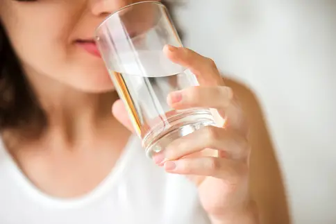 photo of woman drinking glass of water